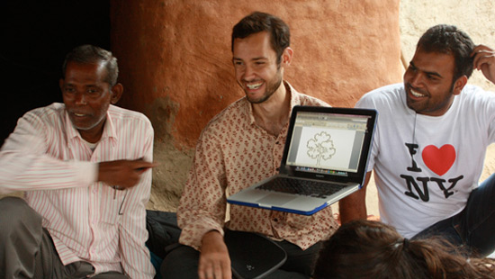 Northwestern Student showing a computer to a couple of people