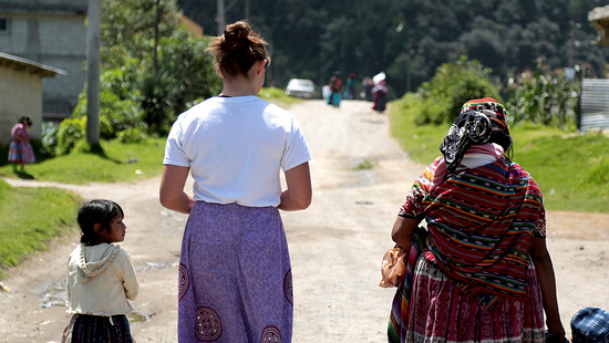 Northwestern student walking in a village.