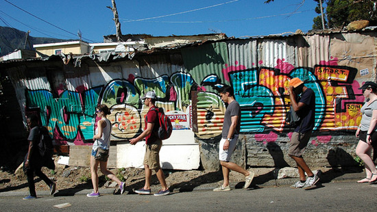 Northwestern students walking in front of graffiti-covered buildings