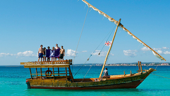 Students on a boat with NU flag