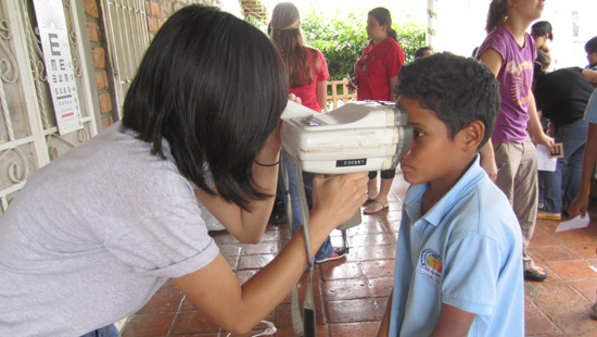 Northwestern student performs eye exam.