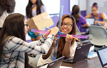 two students assembling a prototype