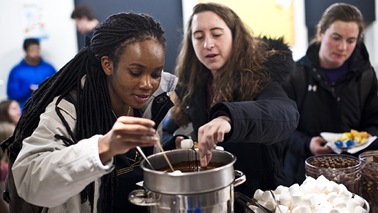Students dipping fondue for an event