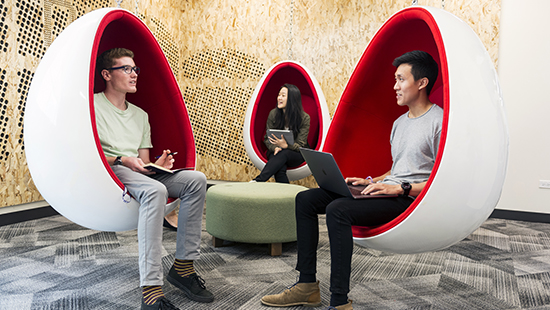 Students sitting in study chairs and talking