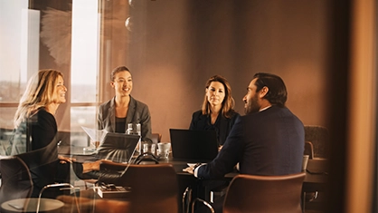 four people in a meeting room