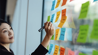 woman writing on post notes