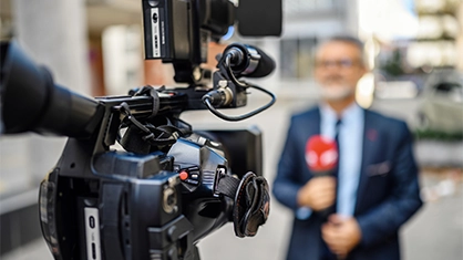 male reporter on camera