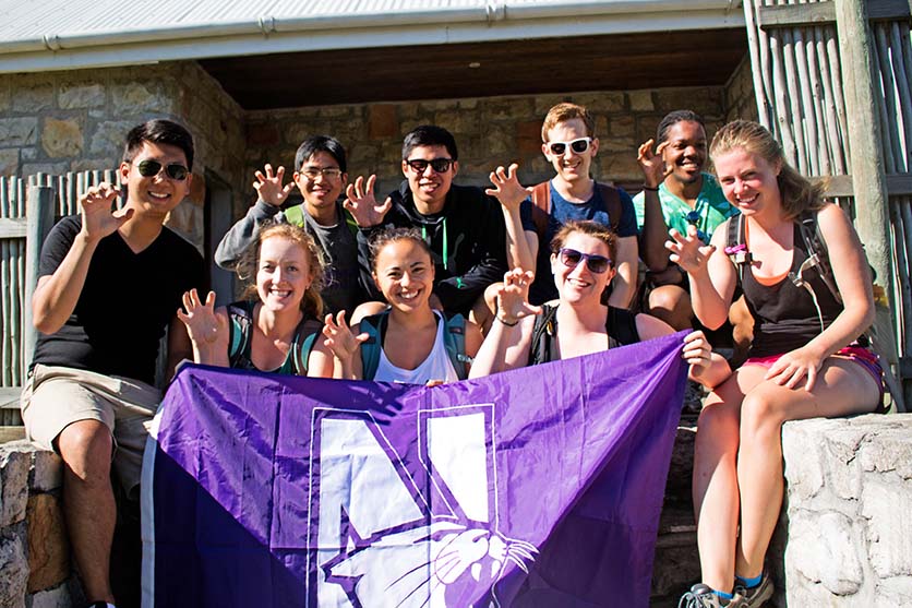 students holding Northwestern flag