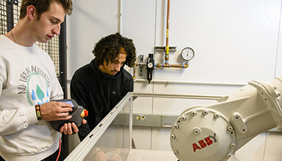 student controlling a robot arm