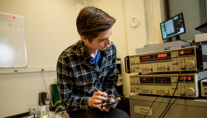 student testing a circuit board
