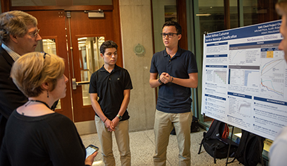 two students presenting a poster