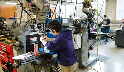 student working in a machine shop