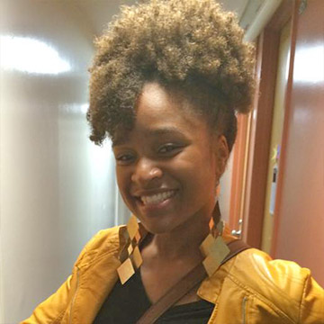 Lady with yellow shirt while smiling.