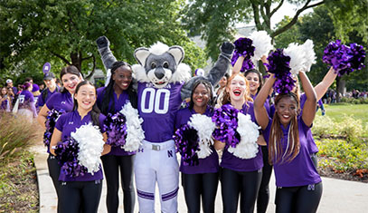 Willie the Wildcat mascot with students
