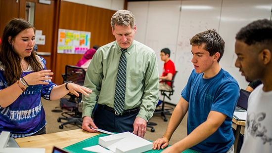 Teacher working with students